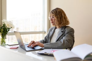 side-view-woman-typing-laptop