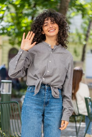 young-woman-smiling-friendly-camera-waving-hands-hello-hi-greeting-goodbye-city-street